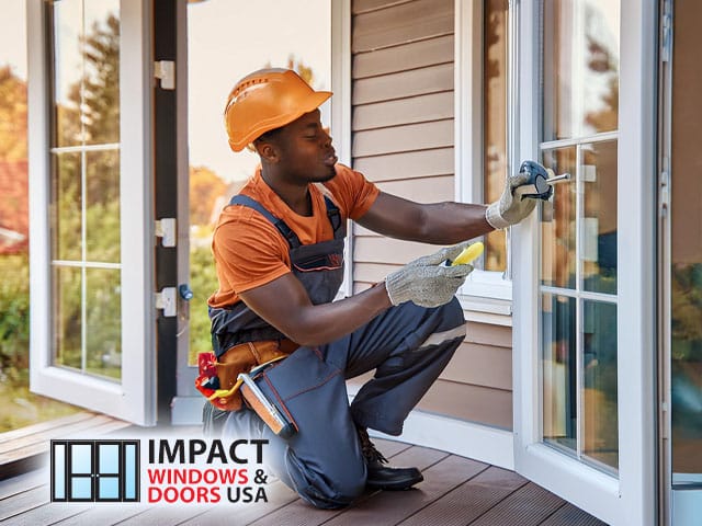 impact windows male repair technician installing energy efficient windows and doors on house